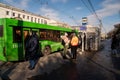 Bus stop Cinema Luch with a white trolleybus and a green bus slowing down and people waiting on Prospekt Mira on a spring day