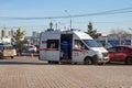 A doctor will climb into a white ambulance that stands in the Northern district of Krasnoyarsk, near the parking lot in the fall