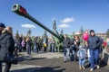 People are walking on the central square of Krasnoyarsk among the exhibition of artillery big guns, during the celebration.