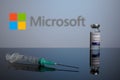 Microsoft Logo with Covid Inoculation Vial and Syringe