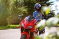 KRASNOYARSK, RUSSIA - AUGUST 09, 2017: A Girl motorcyclist wearing a helmet and red sport bike Honda CBR 600 RR PC37 2005