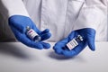 Doctor Offers Moderna and Astrazeneca Covid Vaccines - Medical Lab Photo