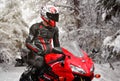 KRASNOYARSK, RUSSIA - July 17, 2018: Beautiful motorcyclist in full gear and helmet on a red and black Honda 2005 CBR 600 RR