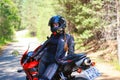KRASNOYARSK, RUSSIA - June 23, 2018: Beautiful girl motorcyclist in full gear and helmet on a red and black Honda 2005 CBR 600 RR