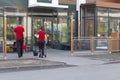 McDonald`s workers clean up on the street near the restaurant