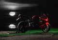 KRASNOYARSK, RUSSIA - May 27, 2019: Red and black sportbike Honda CBR 600 RR 2005 PC37 near the river at night. The moon shines on Royalty Free Stock Photo