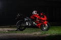 KRASNOYARSK, RUSSIA - May 27, 2019: Red and black sportbike Honda CBR 600 RR 2005 PC37 on the track at night. Light effect