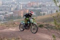 Krasnoyarsk, Russia, 2022 05 24: Motorcycle racer biker on a cross-country motorcycle bike jump springboard against the