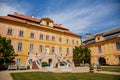 Krasny Dvur Chateau, North Bohemia, Czech Republic, 19 June 2021: Baroque yellow castle with stairs, front yard with green lawn