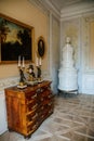 Krasny Dvur Chateau, North Bohemia, Czech Republic, 19 June 2021: Castle interior, baroque furniture, antique clock on dresser