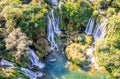 Kravica karst forest waterfall cascades flows with boat on the lake surface, Trebizat river, Bosnia and Herzegovina