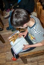 The boy reading the Bible at a lesson in the children`s Christian camp