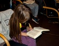 The girl reading the Bible at a lesson in the children`s Christian camp