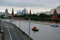Kremlin in Moscow, the river front with the vehicle, behind the skyscrapers Royalty Free Stock Photo
