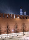 The Kremlin Wall and cathedrals after it in Moscow Russia with holiday lighting during cold Russian winter blizzard on night Royalty Free Stock Photo
