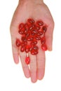 Krill oil capsules. Red gelatin capsules with krill oil in hand isolated on white background. omega fatty acids.Close up