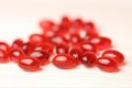 Krill oil red gelatin capsules on a white wooden background .omega fatty acids.Natural supplements and vitamin Royalty Free Stock Photo