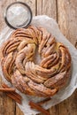 Kringle Delicious Brioche with sugar and cinnamon closeup on the paper. Vertical top view