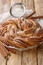 Kringle Delicious Brioche with sugar and cinnamon closeup on the paper. Vertical