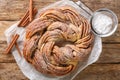 Kringle or pretzel traditional Christmas dessert in Northern Europe with cinnamon closeup on the paper. Horizontal top view