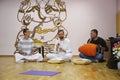 Krishna guru playing musical instrument karatals in a temple for parishioners