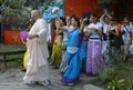 Krishna guru preaching with microphone standing among crowd of followers, fest camp. Festival Vedalife. Kyiv, Ukraine Royalty Free Stock Photo