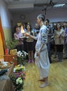 Krishna monk lighting sacred cleaning fire in a temple for prayer, parishioners watching