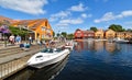 Motorboats navigate on a canal in the Fiskebrygga district in Kristiansand, Norway