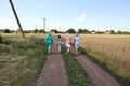 Krivoy Rog, Ukraine, June, 22,2019. Women walking along a rural road and wheat field.