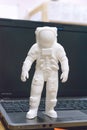 Kropivnitskiy, Ukraine Ã¢â¬â 12 may, 2018: 3D printed astronaut, cosmonaut, robot on the background of devices and laptop. Spaceman