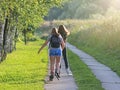 Krosno, Poland - july 9 2018:Two girls in beautiful festive dresses ride on bicycles along the historic streets of the baroque tow