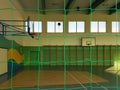 Krosno, Poland - may 27, 2018: Gymnastic multifunctional hall in green colors with a basketball field and a grid on the windows fo