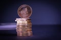 A Krugerrand gold coin stands on a stack of other gold coins Royalty Free Stock Photo