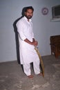 Kshatriya youth, wearing white kurta while shooting photo with sword. Indian hindu traditional costumes Royalty Free Stock Photo