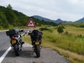 KTM and BMW motorcycle parked on a Croatian highway