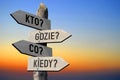 Kto? Gdzie? Co? Kiedy? Polish/ Who? Where? How? When? English - wooden signpost, sunset sky Royalty Free Stock Photo