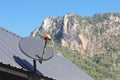KU-Band satellite dish on the roof with mountain and blue sky background Royalty Free Stock Photo