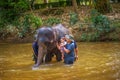 Malaysians bath with a baby elephant