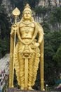 Huge and golden Hindu statue of lord Murugan at Batu caves in Kuala