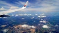 KUALA LUMPUR, MALAYSIA - APR 11th, 2015: Wing view during flight with a airplane with blue skys and clouds