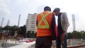 Construction workers discuss among themselves regarding technical issues at the construction site. Royalty Free Stock Photo