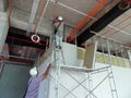 Drywall installation work in progress by construction workers at the construction site. Royalty Free Stock Photo