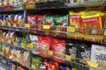 Packed miscellaneous junk foods & snacks on rack for sale