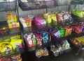 Packed miscellaneous junk foods & snacks on rack for sale