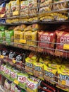 Selective focused of packed miscellaneous brand and type of junk foods & snacks on rack and display for sale in the supermarket.