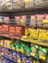 Selective focused of packed miscellaneous brand and type of junk foods & snacks on rack and display for sale in the supermarket.