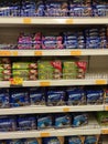 Variety of biscuits in good and interesting packaging and displayed on the racks inside the shop.