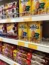 Variety of biscuits in good and interesting packaging and displayed on the racks inside the shop.