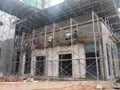 Brick wall plastered by construction workers using the cement plaster.