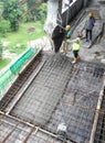 Concreting work by construction workers at the construction site.